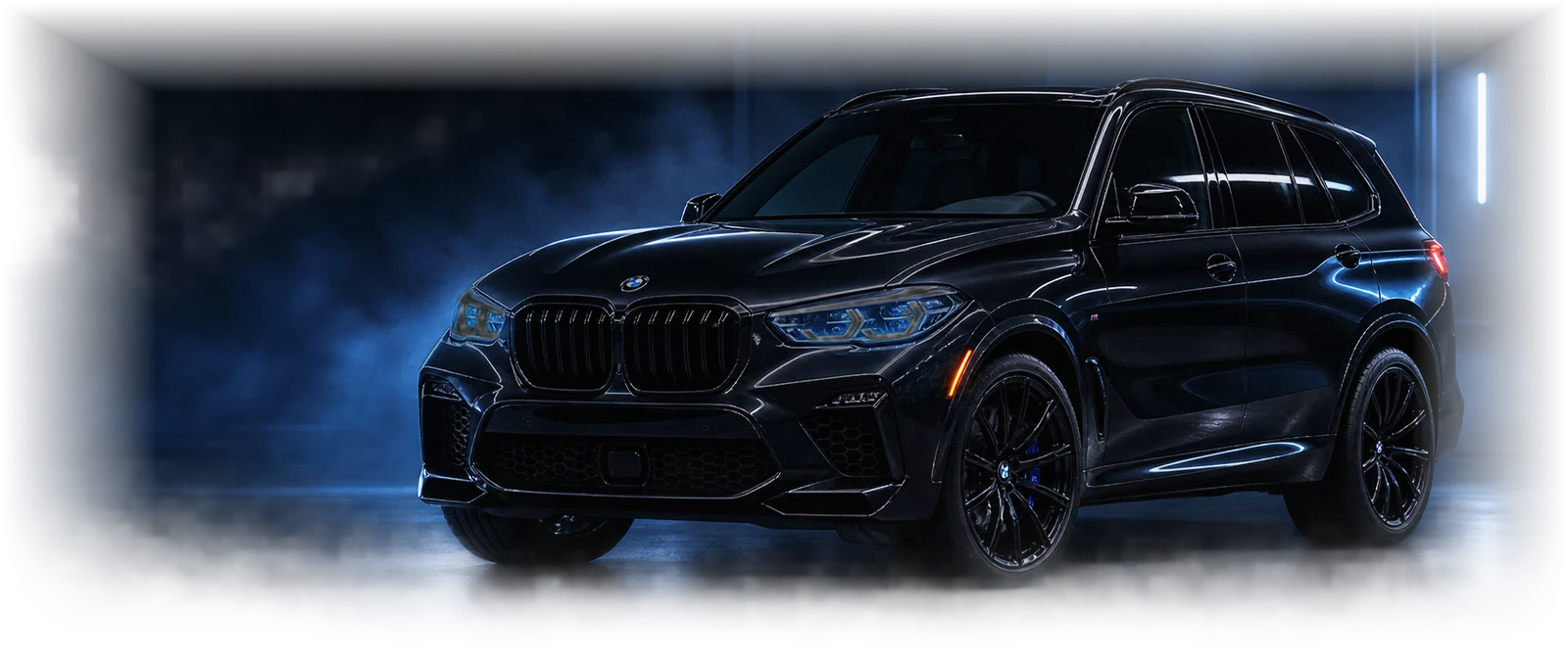 Dark premium vehicle in the Grandett studio under controlled blue lighting